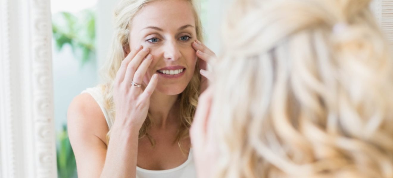 picture of a a middle age woman looking at herself in a mirror