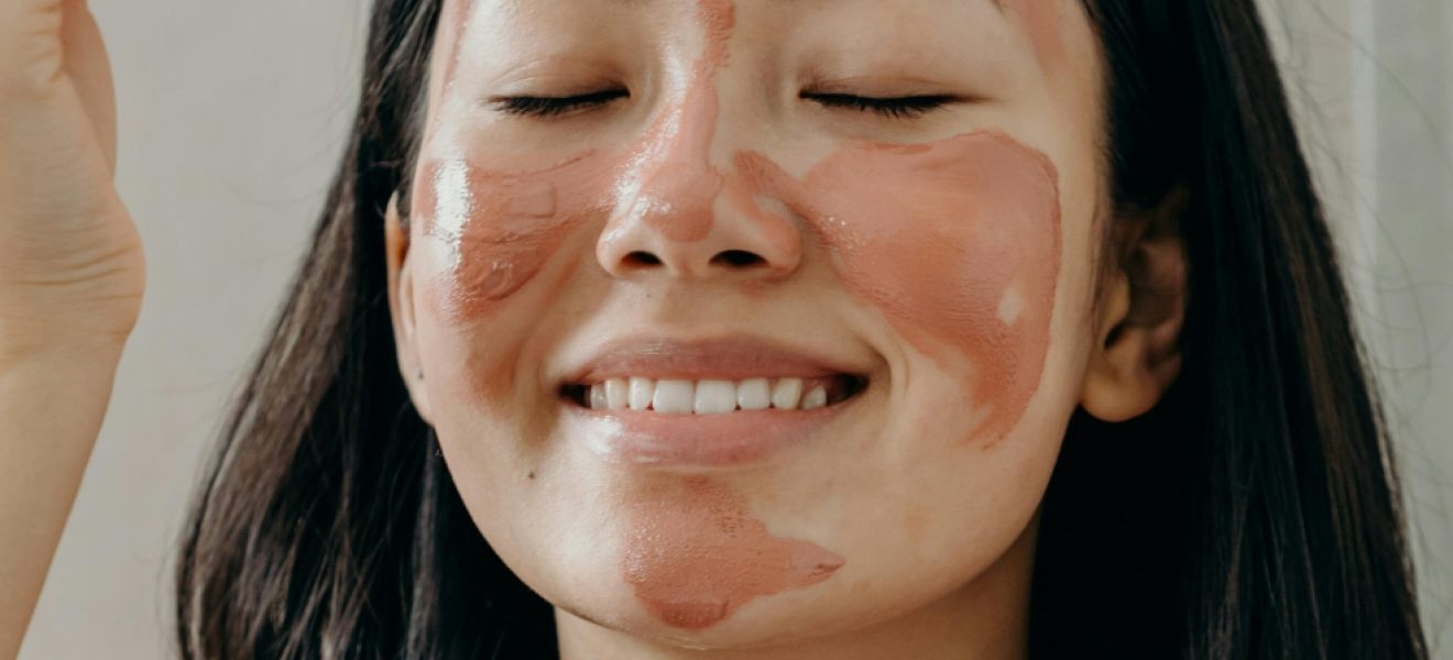 picture of a woman applying a face mask as part of a night time skincare routine