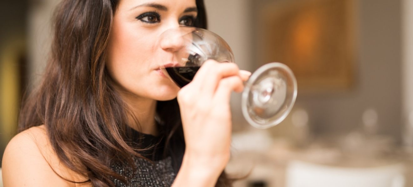picture of a woman drinking a glass of red wine