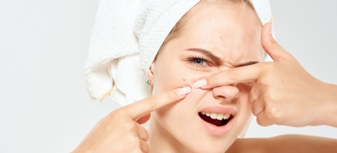 a woman wearing a hair towel squeezing a face pimple.jpeg mage of a woman wearing a hair towel squeezing a face pimple.jpeg