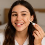 picture of a happy teenager Applying Concealer with a Smile